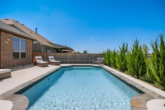 a view of a backyard with sitting area