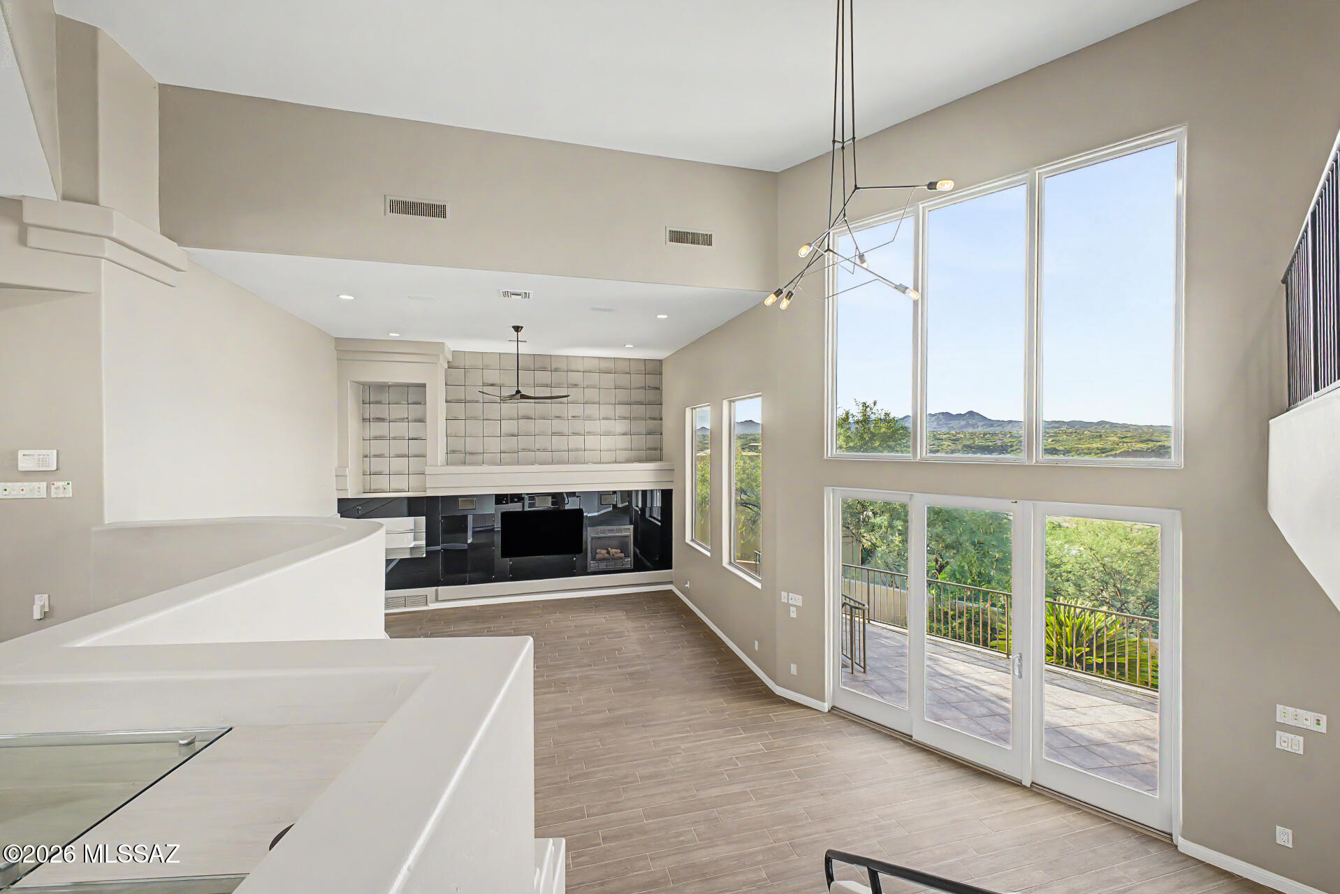 1751 East Buck Ridge Place Tucson, AZ 85737 - Photo 19 of 46 GREAT ROOM VIEWS WITH FIREPLACE, TV & CUSTOM ENTERTAINMENT SPACES