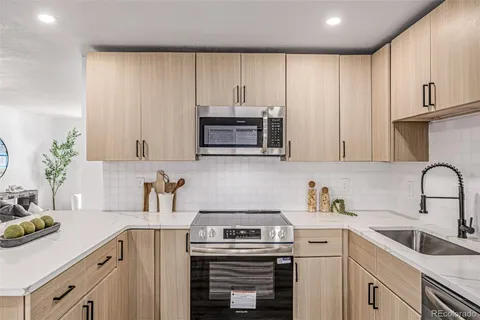 a kitchen with cabinets a sink and a stove