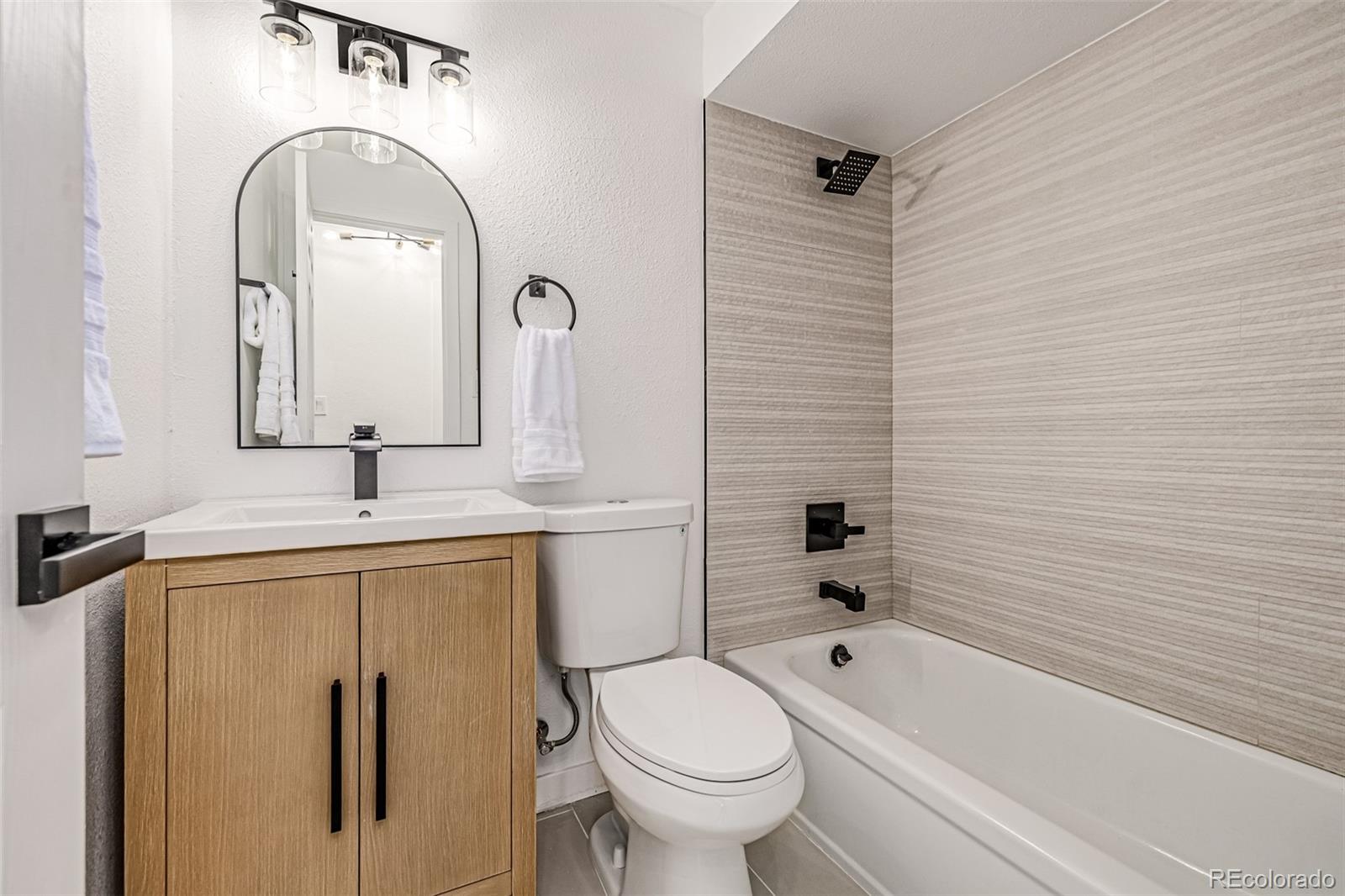 3831 West Rutgers Place Denver, CO 80236 - Photo 19 of 35 a bathroom with a sink a toilet and shower
