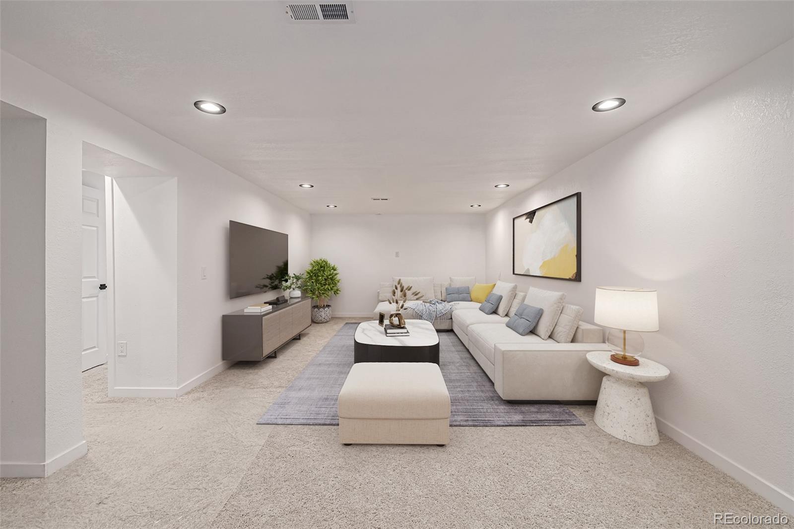 3831 West Rutgers Place Denver, CO 80236 - Photo 20 of 35 a living room with furniture a flat screen tv and a lamp
