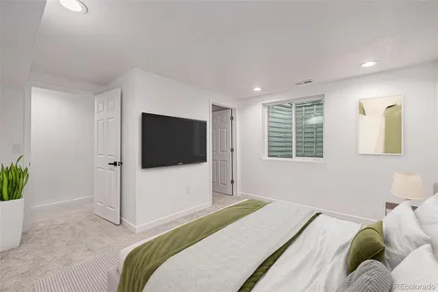 a bedroom with a bed and a television