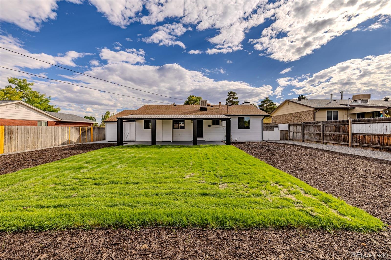 3831 West Rutgers Place Denver, CO 80236 - Photo 29 of 35 a view of a house with a yard