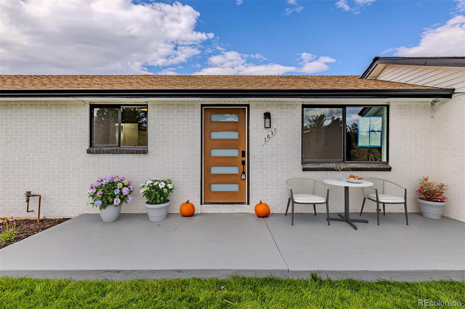 3831 West Rutgers Place Denver, CO 80236 - Photo 3 of 35 a front view of a house with sitting area