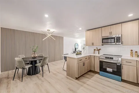 a kitchen with a table chairs stove and cabinets