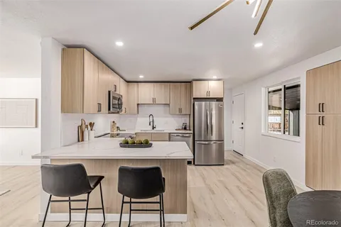 a kitchen with refrigerator and cabinets