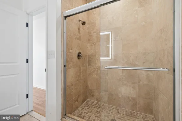 a bathroom with a granite countertop toilet sink a mirror a bathtub and vanity