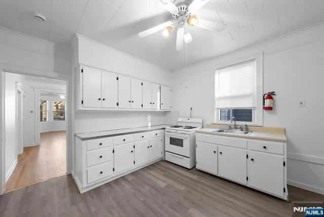 a kitchen with cabinets a sink and appliances