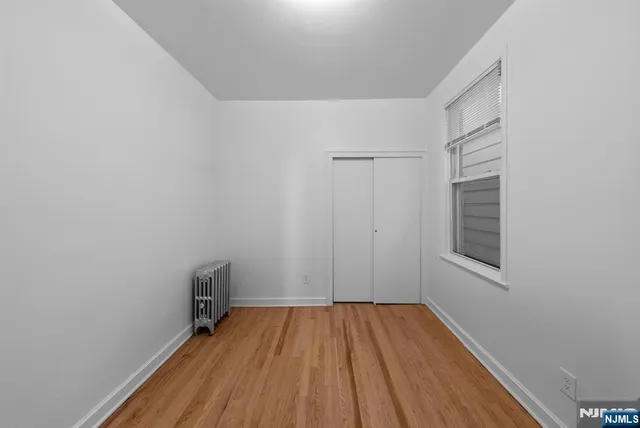 a view of a room with wooden floor and small space