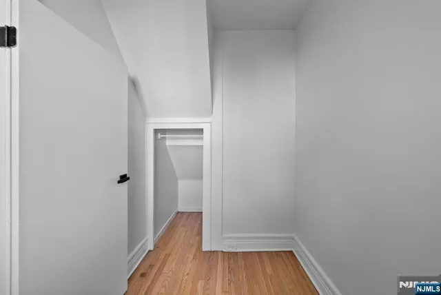 a view of a room with wooden floor