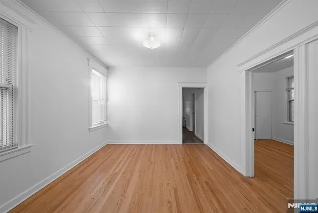 a view of a room with wooden floor and window