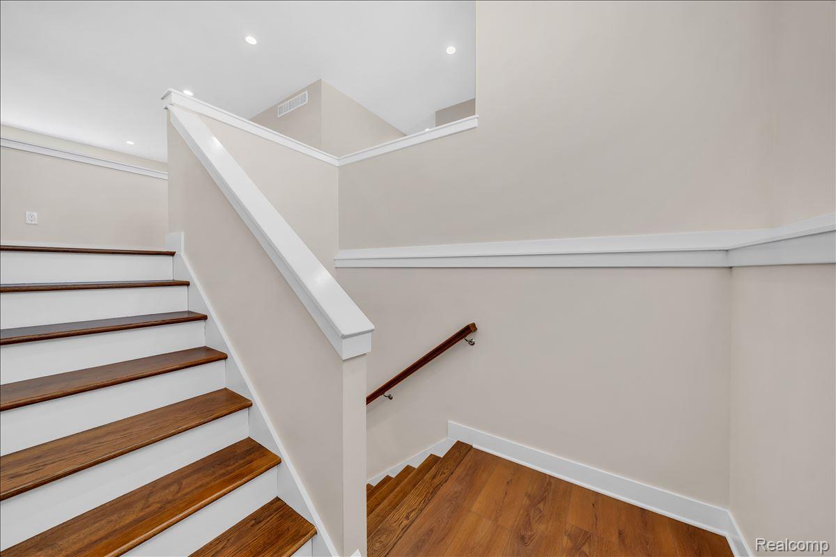 4266 McCandlish Road Grand Blanc, MI 48439 - Photo 37 of 68 Staircase featuring wood-finish treads, white risers, and a white balustrade