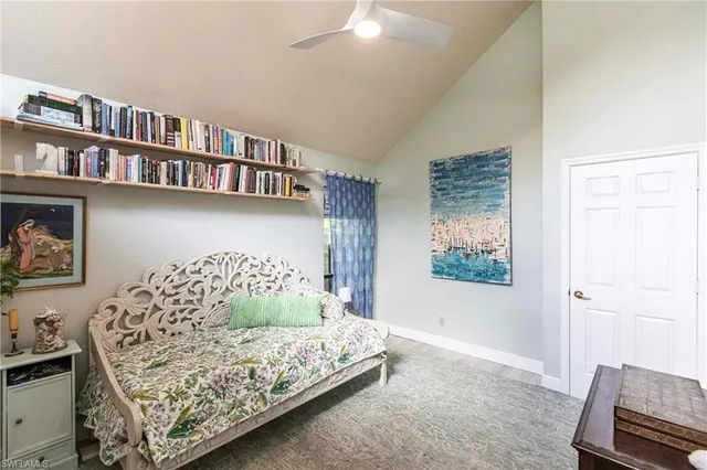 a bedroom with furniture and a book shelf