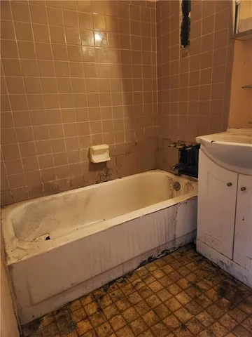 a bathroom with a bathtub and a sink