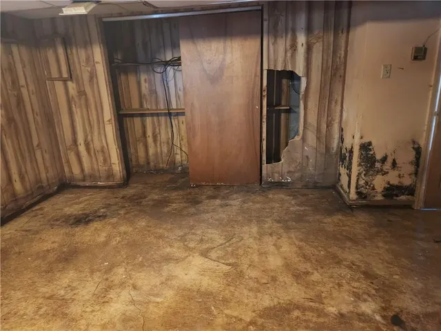 a view of a room with wooden floor and cabinet