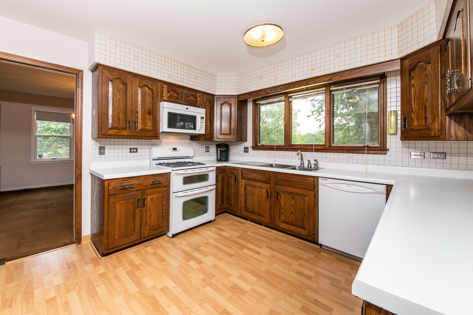 1701 Banbury Road Inverness, IL 60067 - Photo 13 of 33 a kitchen with a stove a sink and a microwave