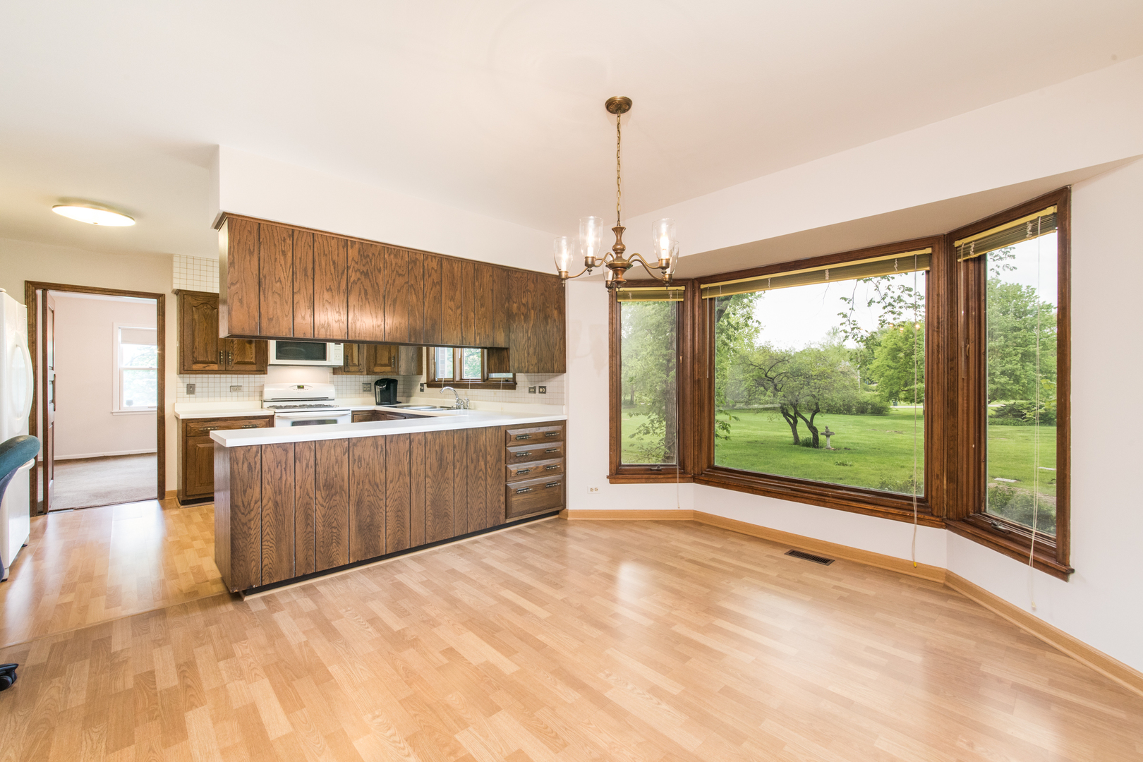 1701 Banbury Road Inverness, IL 60067 - Photo 14 of 33 a kitchen with stainless steel appliances kitchen island granite countertop a refrigerator a sink and a wooden floors