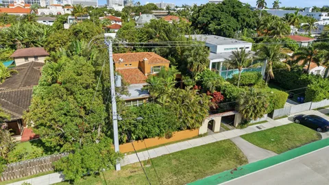 an aerial view of a house with a yard basket ball court and outdoor seating