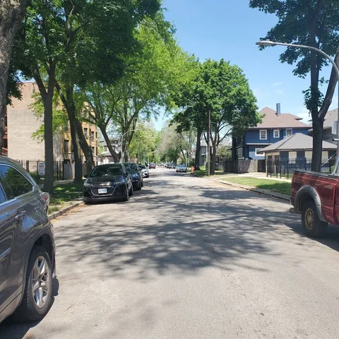 a view of street with parked cars