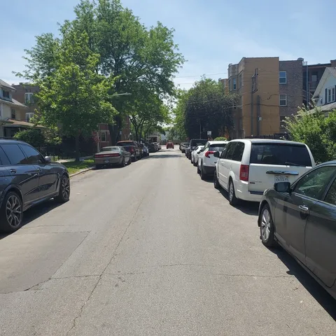 a view of street with parked cars
