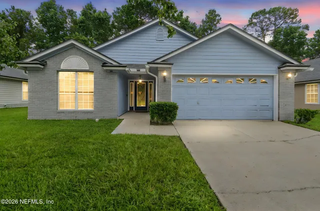 a front view of a house with a yard and garage