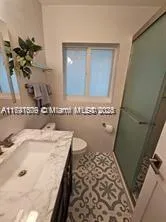 a bathroom with a sink a toilet and mirror