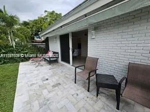 a view of a backyard with sitting area