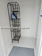 a view of staircase with wooden floor and mirror