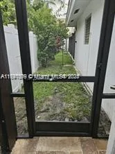 a living room with a large window a table and chairs