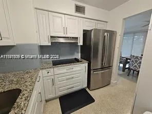 a kitchen with appliances and cabinets