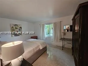 a bedroom with a bed and a table in it