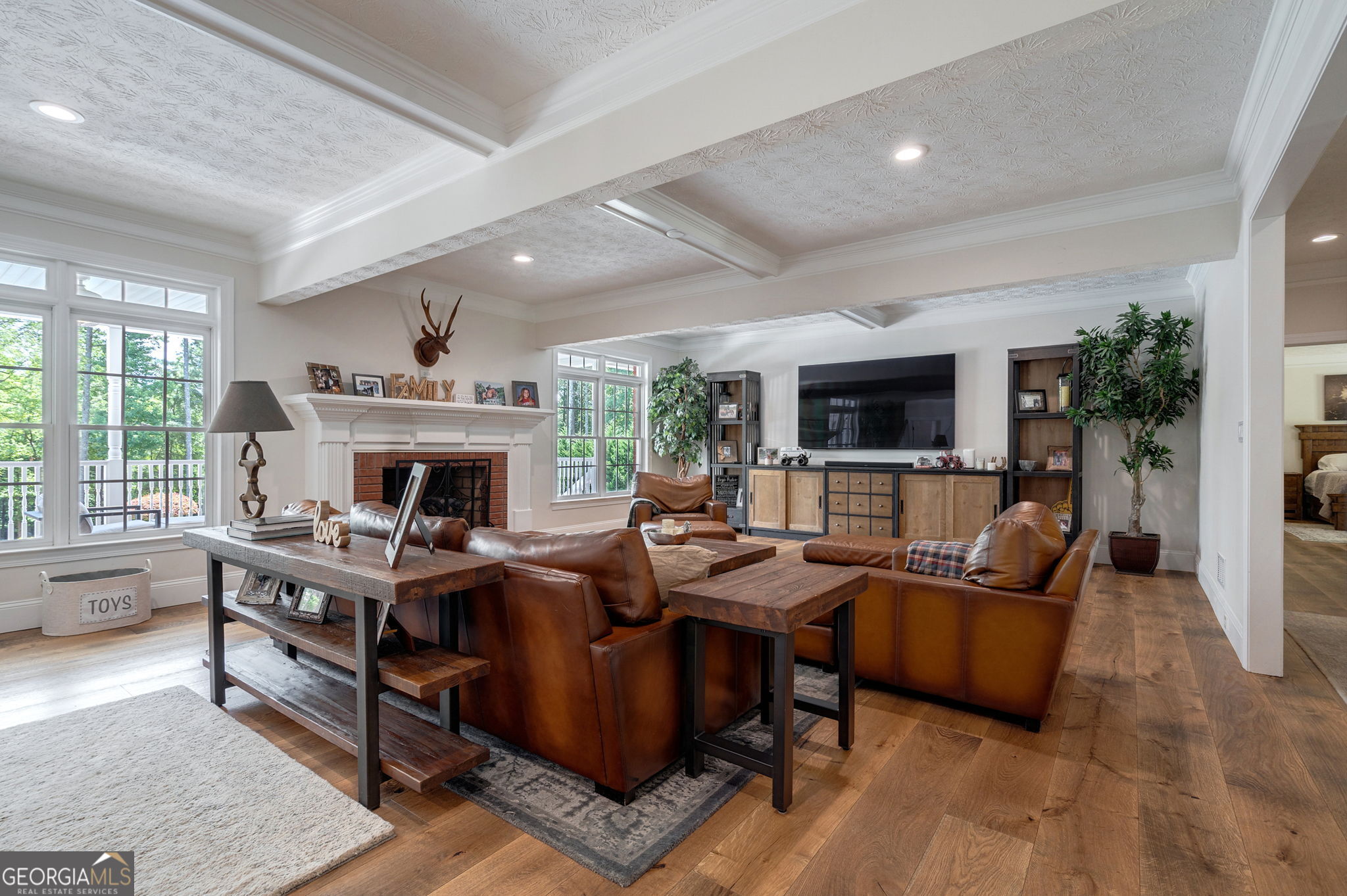 2391 Rabbit Farm Circle Loganville, GA 30052 - Photo 18 of 97 a living room with furniture a fireplace and a flat screen tv