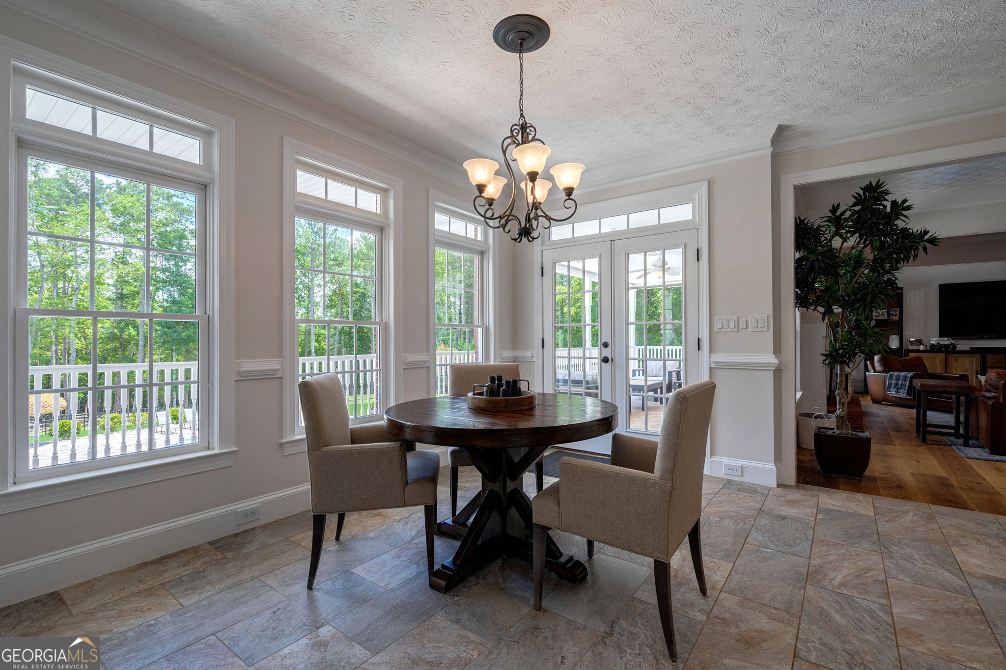 2391 Rabbit Farm Circle Loganville, GA 30052 - Photo 29 of 97 a dining room with furniture a chandelier and a rug