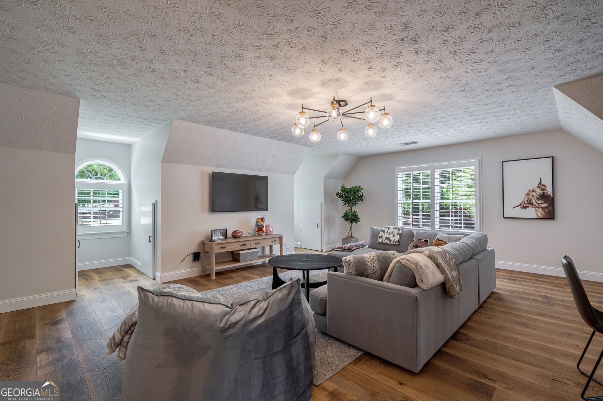 2391 Rabbit Farm Circle Loganville, GA 30052 - Photo 45 of 97 a living room with furniture wooden floor and a large window