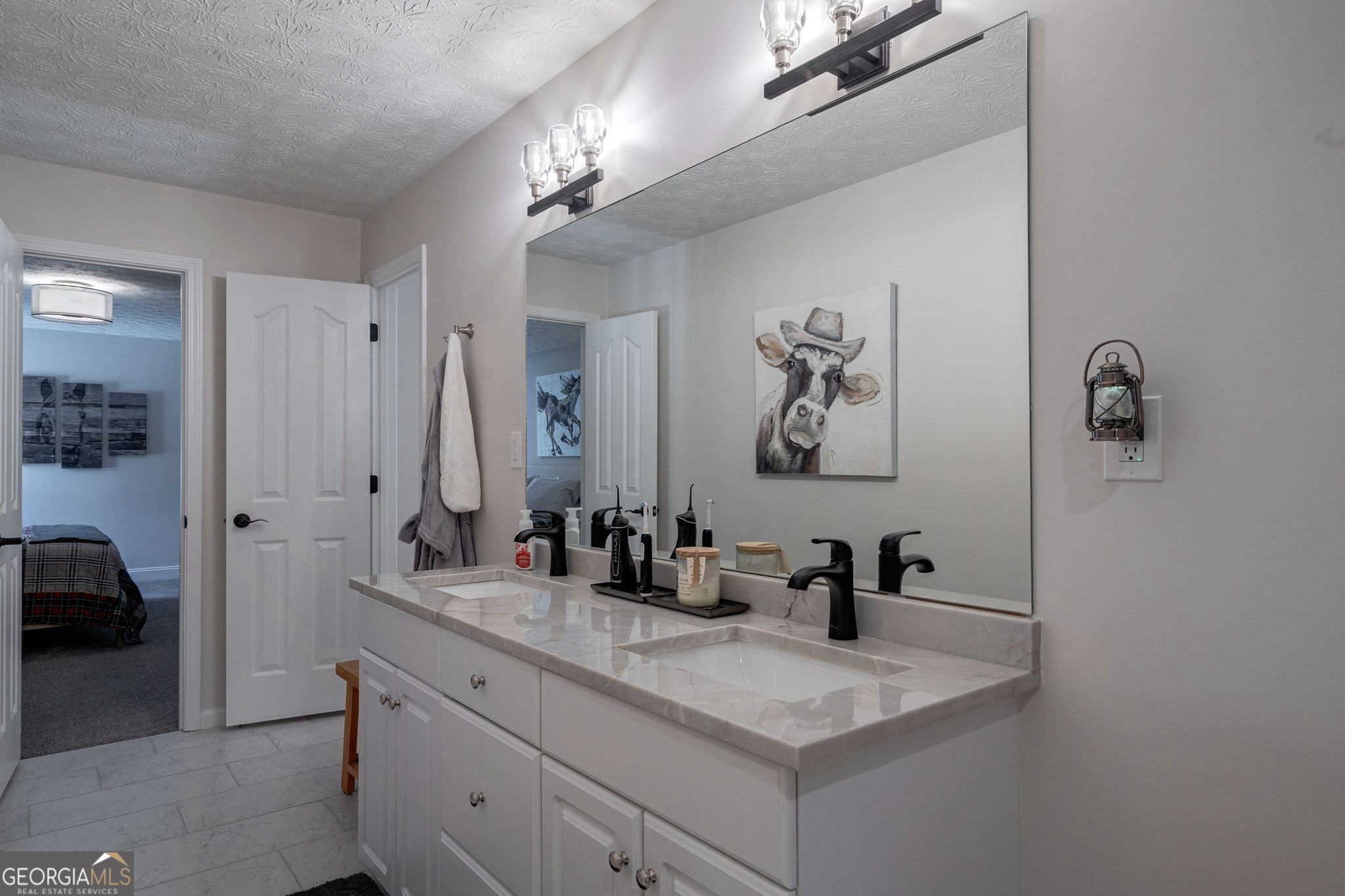 2391 Rabbit Farm Circle Loganville, GA 30052 - Photo 50 of 97 a bathroom with a sink a mirror and a shower