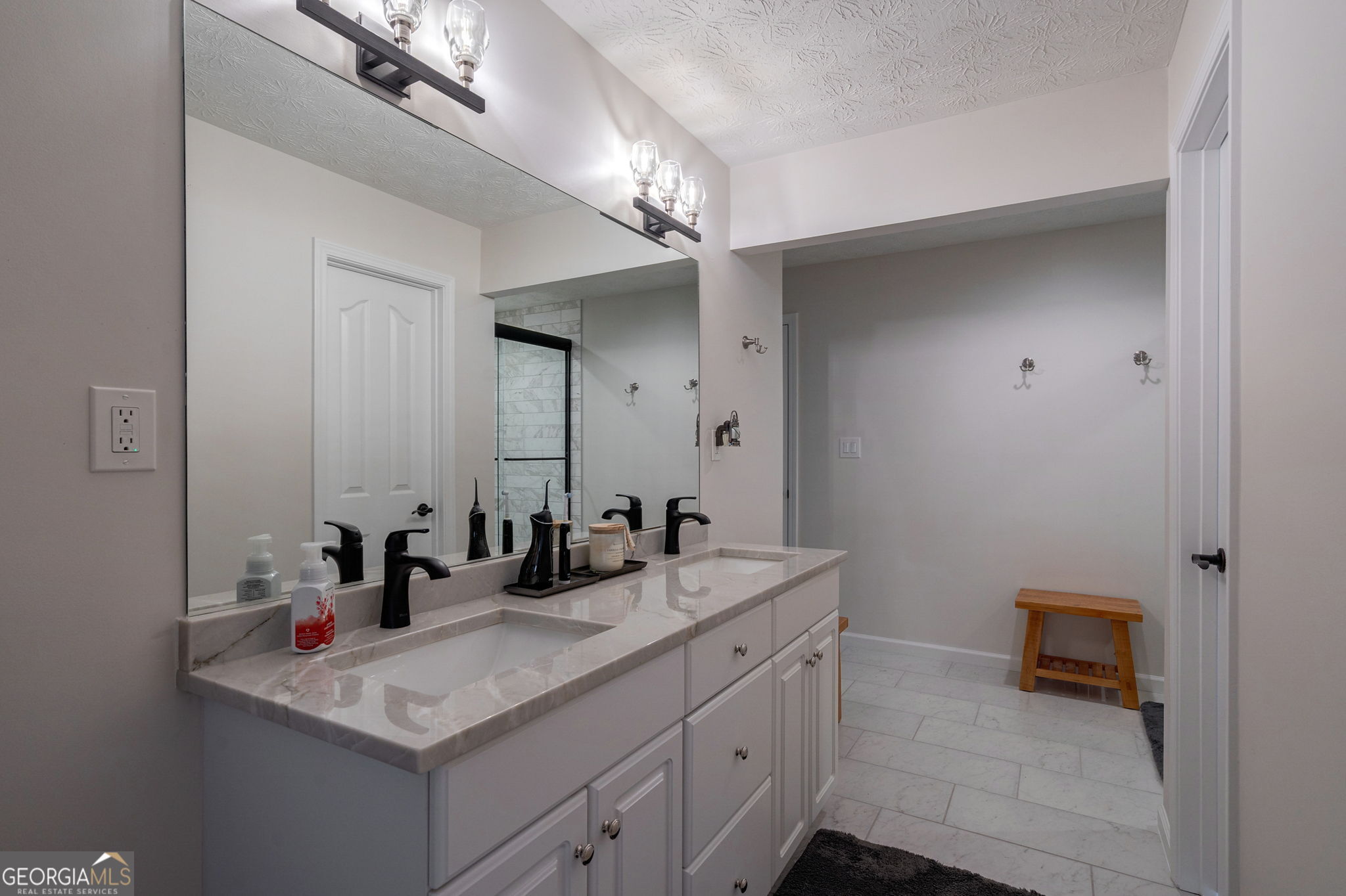 2391 Rabbit Farm Circle Loganville, GA 30052 - Photo 51 of 97 a bathroom with a sink a light fixture and a mirror