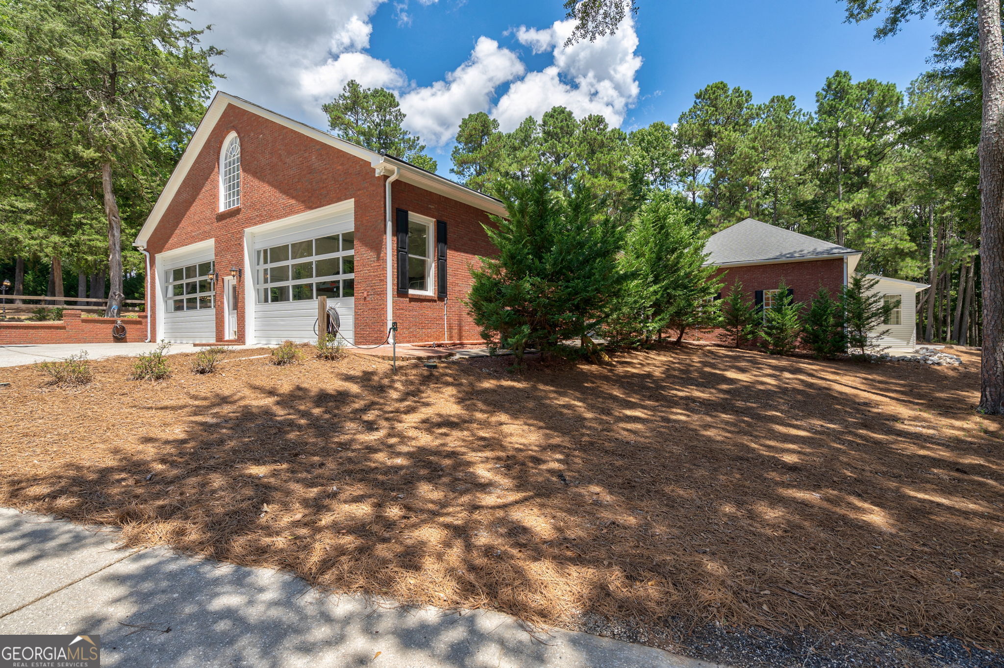 2391 Rabbit Farm Circle Loganville, GA 30052 - Photo 75 of 97 a front view of a house with a yard and trees