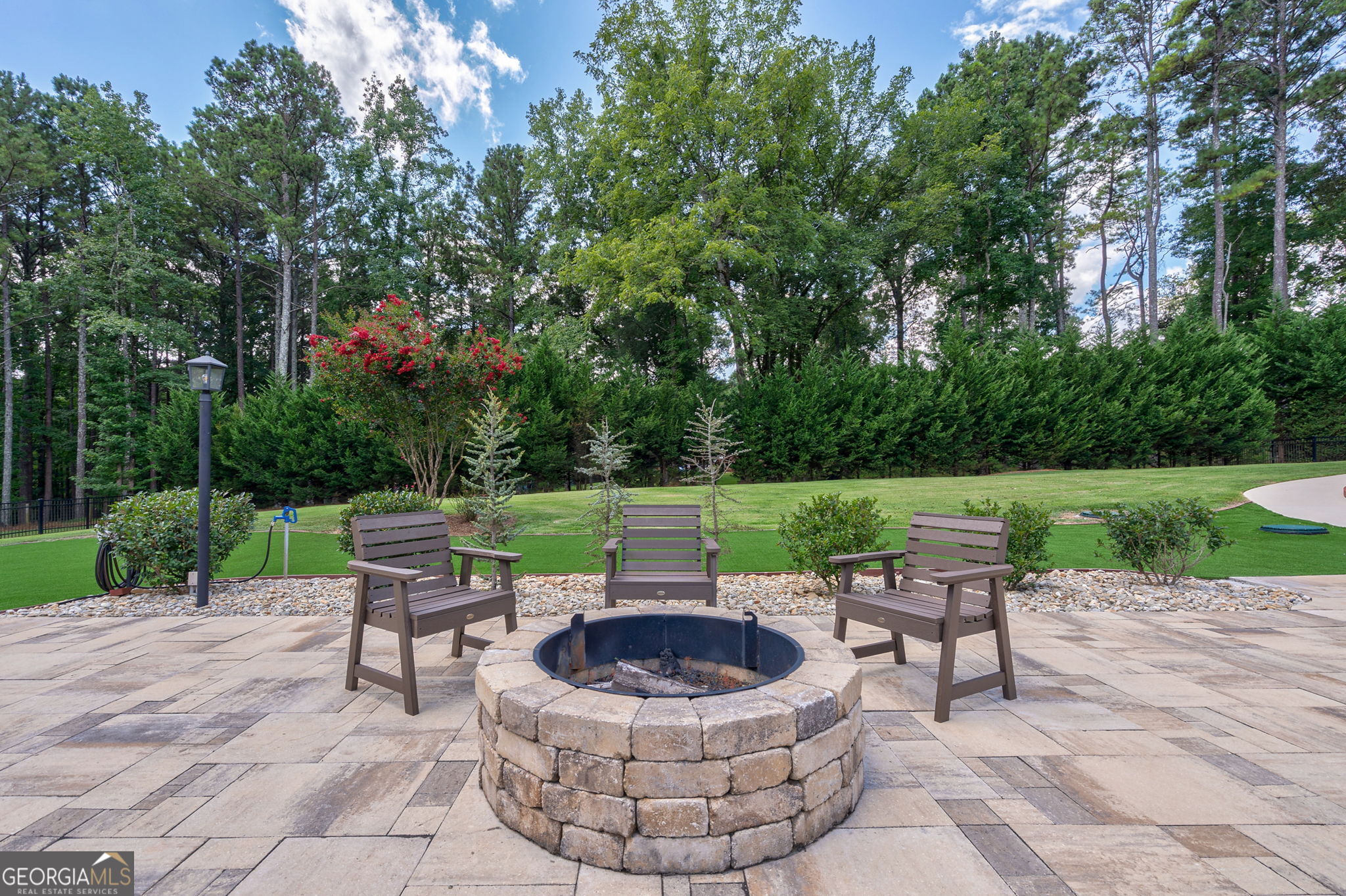 2391 Rabbit Farm Circle Loganville, GA 30052 - Photo 90 of 97 a view of a patio with a table chairs and a fire pit