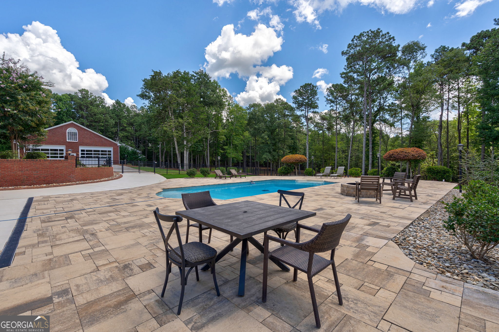 2391 Rabbit Farm Circle Loganville, GA 30052 - Photo 91 of 97 a backyard of a house with table and chairs