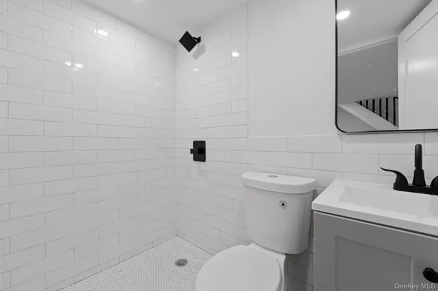 a bathroom with a toilet sink and shower