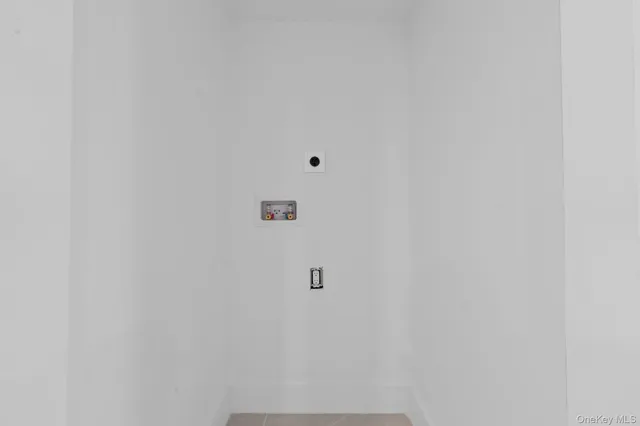 a white wall with white shower