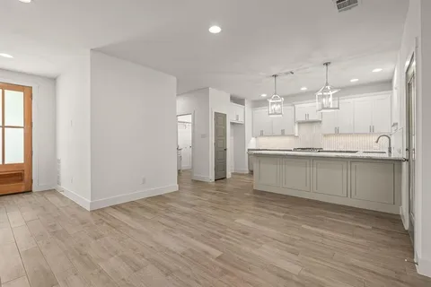 a kitchen with a sink stove and cabinets