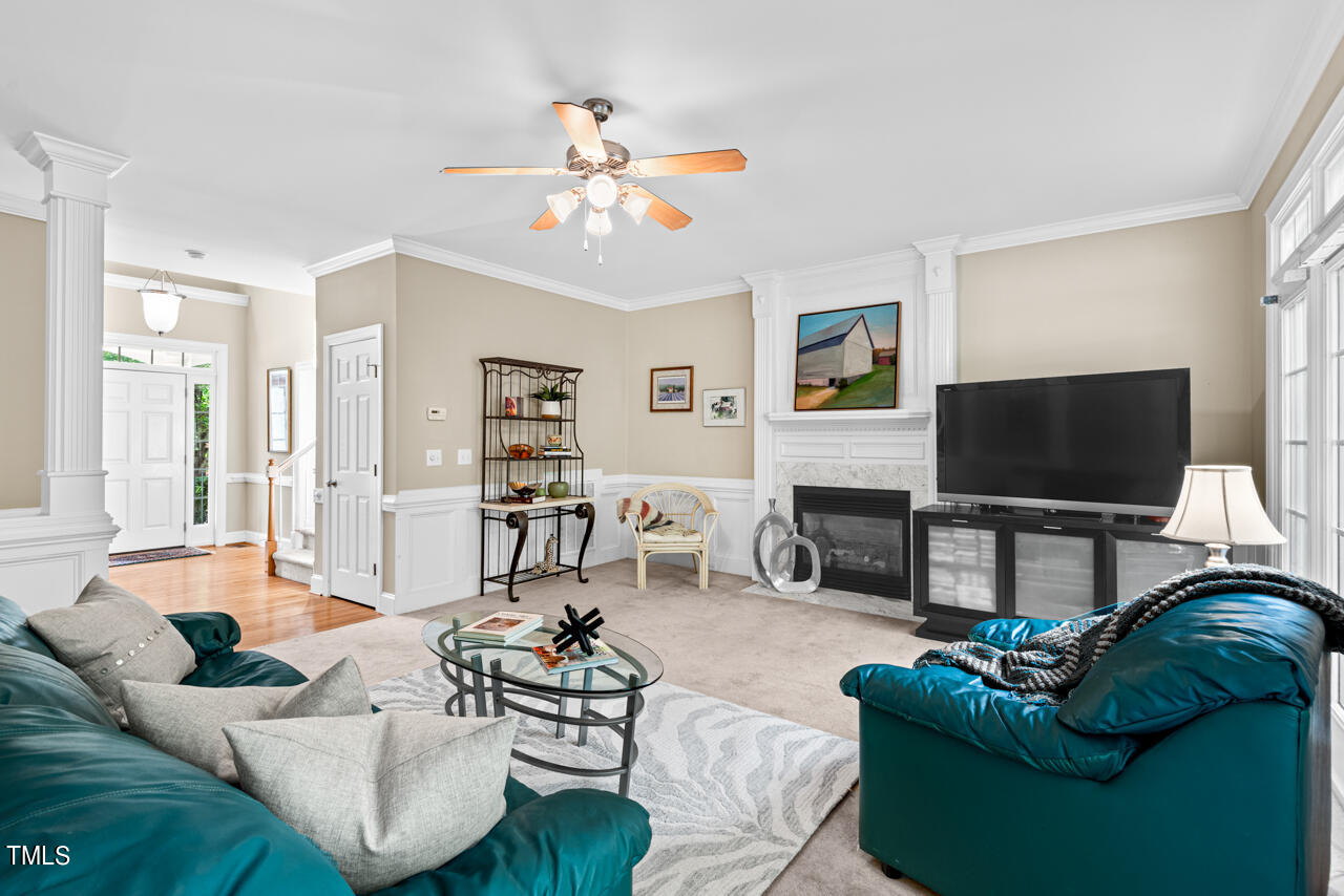 7930 Pine Timber Drive Raleigh, NC 27613 - Photo 12 of 57 a living room with furniture a flat screen tv and a fireplace