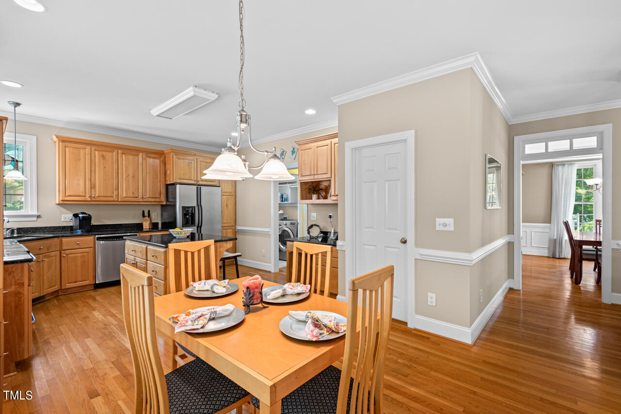 7930 Pine Timber Drive Raleigh, NC 27613 - Photo 19 of 57 a living room with furniture kitchen view and a wooden floor