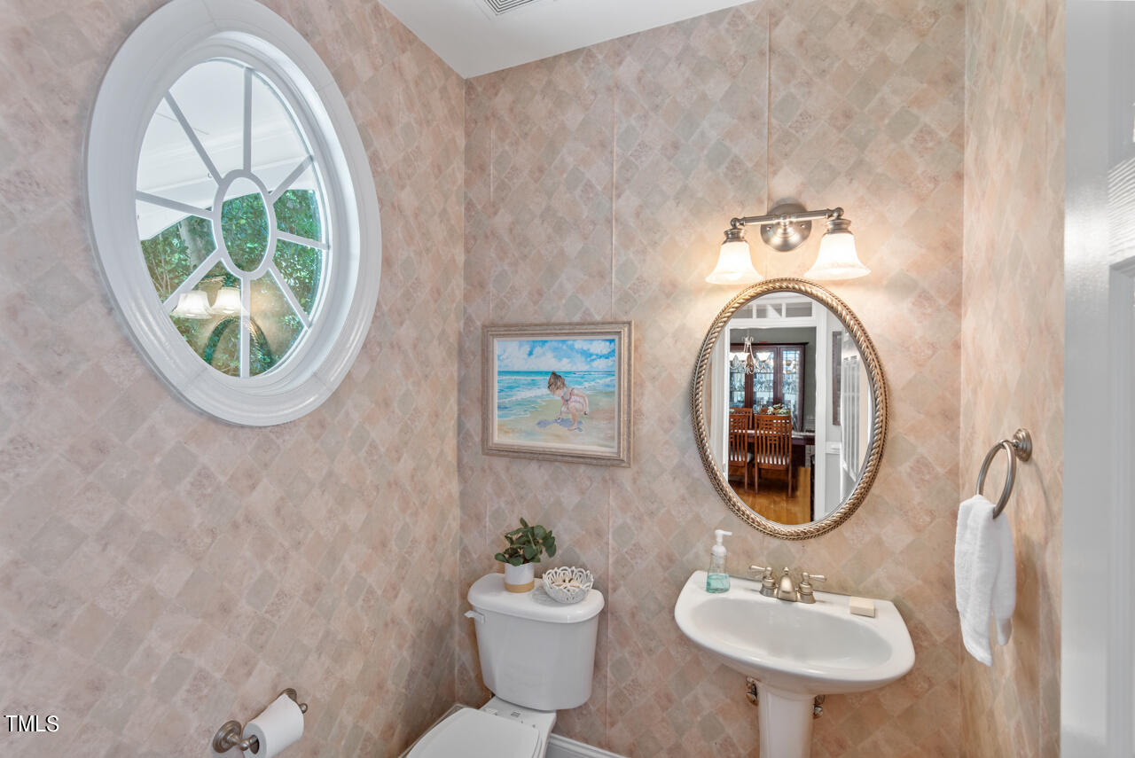 7930 Pine Timber Drive Raleigh, NC 27613 - Photo 29 of 57 a bathroom with a toilet a sink and a mirror
