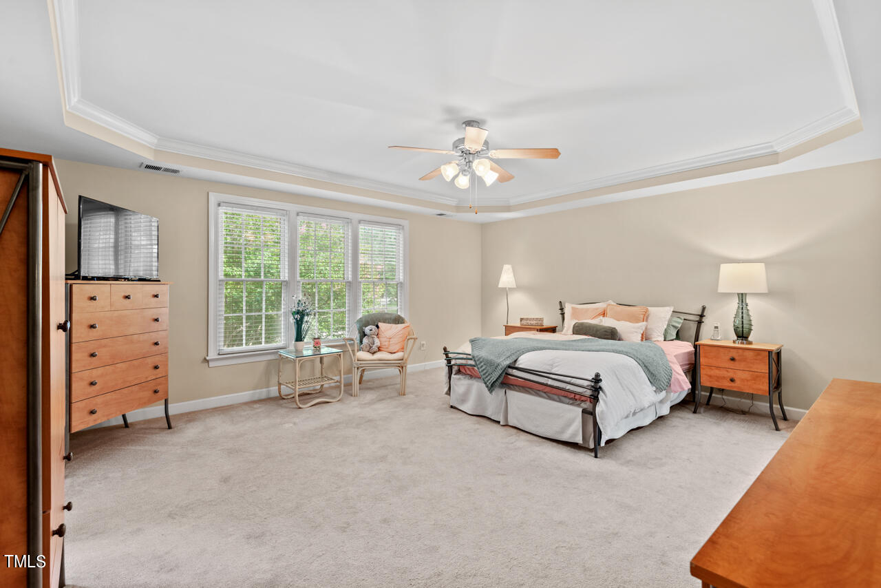 7930 Pine Timber Drive Raleigh, NC 27613 - Photo 31 of 57 a spacious bedroom with a bed and a chandelier