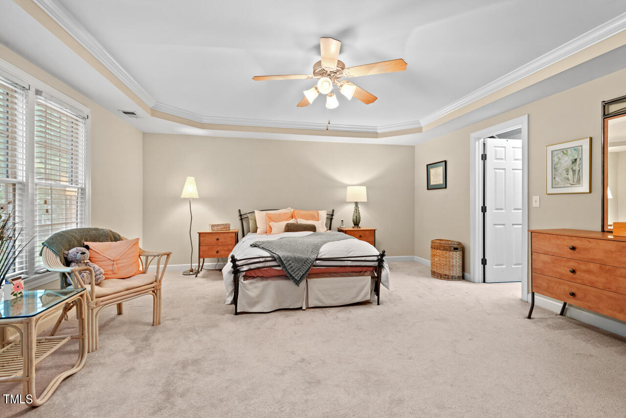 7930 Pine Timber Drive Raleigh, NC 27613 - Photo 33 of 57 a bedroom with furniture and a chandelier