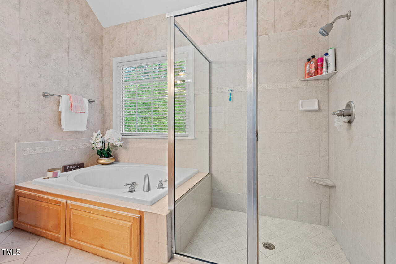 7930 Pine Timber Drive Raleigh, NC 27613 - Photo 36 of 57 a bathroom with a tub sink and a shower