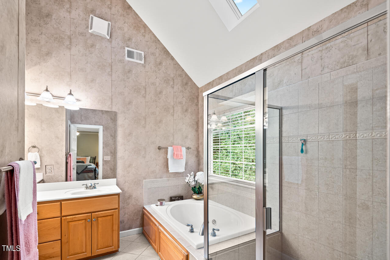 7930 Pine Timber Drive Raleigh, NC 27613 - Photo 40 of 57 a bathroom with a tub sink and mirror