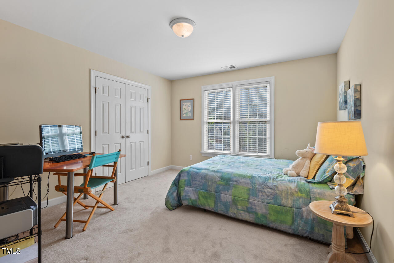 7930 Pine Timber Drive Raleigh, NC 27613 - Photo 41 of 57 a bedroom with a bed and a window